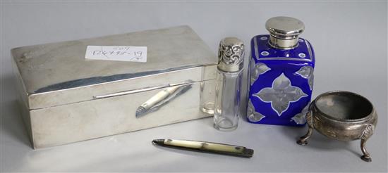 An Edwardian silver cigarette box, two mounted scent bottles, a silver salt and a silver fruit knife.